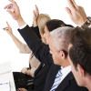 Business lecture with hands raised in the air