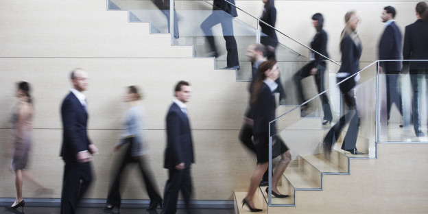 Businesspeople walking on busy office staircase